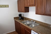 Newly renovated kitchens with brand new wood cabinetry and granite-look counter tops.