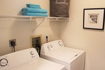 Laundry room with washer and dryer included in every apartment home.