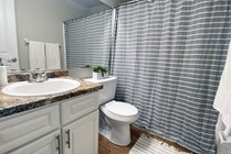 Remodeled bathrooms with updated countertops, wood-style flooring, and modern aesthetics ensure luxurious comfort. 