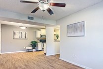 Airy open floor plans with wood-style flooring and ceiling fans offer an elegant, communal living experience. 